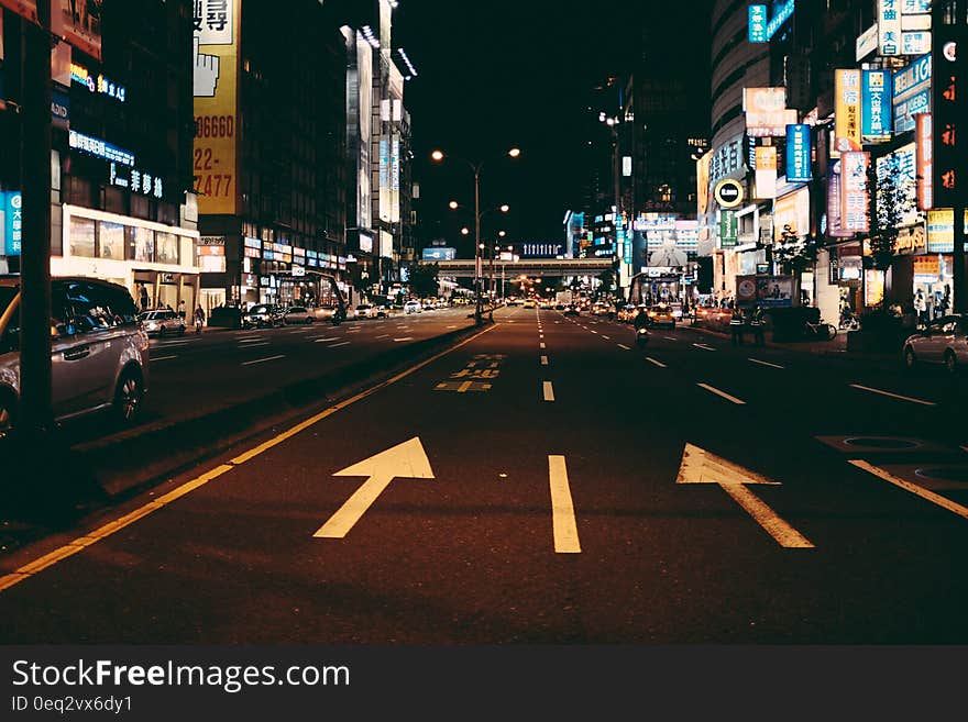 A city photographed at nighttime with lights on the streets. A city photographed at nighttime with lights on the streets.