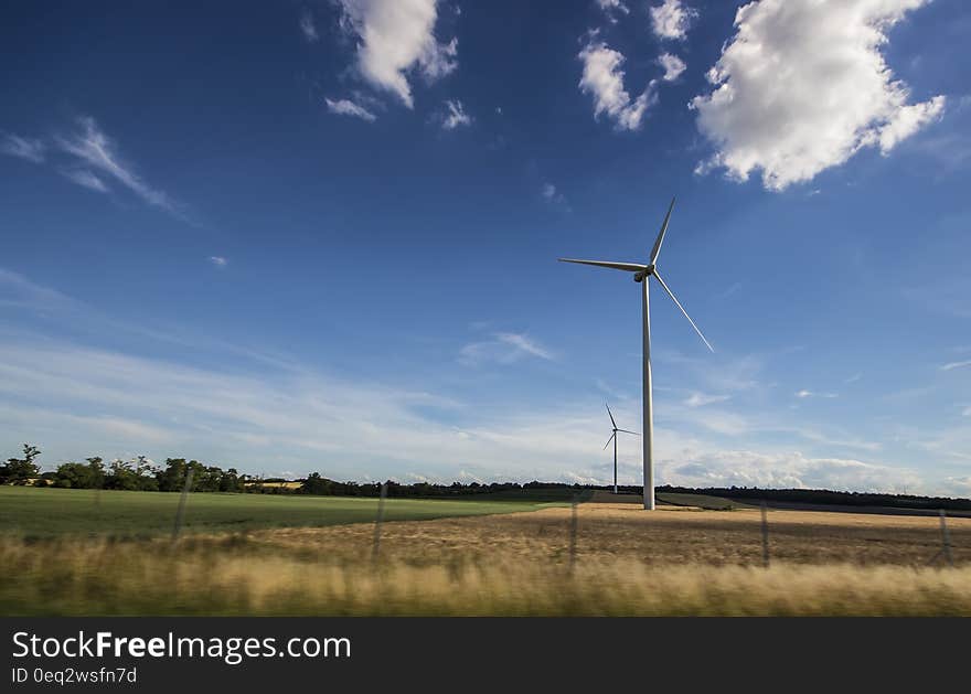 White Windmill Under Blue and White Sky at Daytime