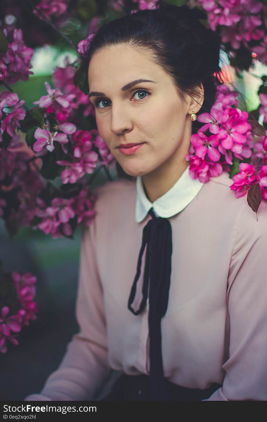 Woman Wearing Pink and White Collared Long Sleeve Dress Shirt Under Blooming Pink Petaled Flower