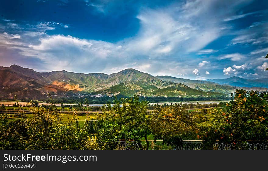 Nature Photography of Mountains and Trees Under Cloudy Sky during Daytime