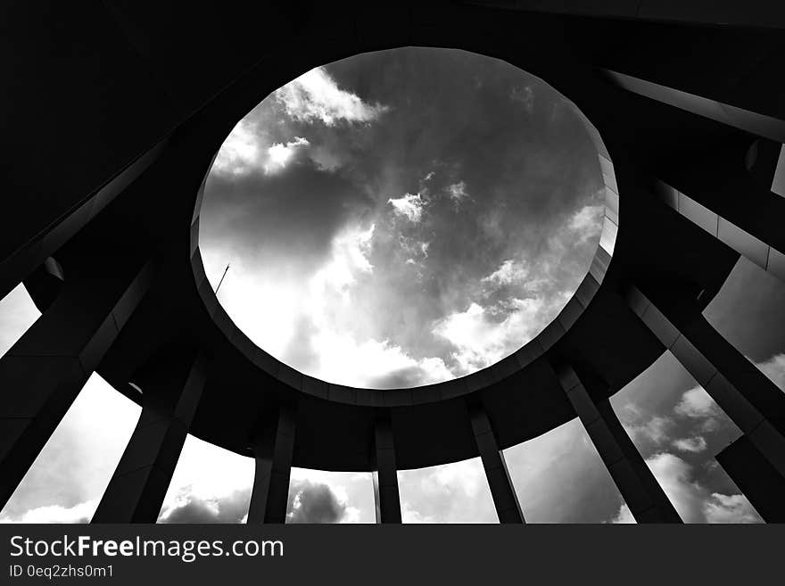 Grayscale Photo of a Round Building With Hole