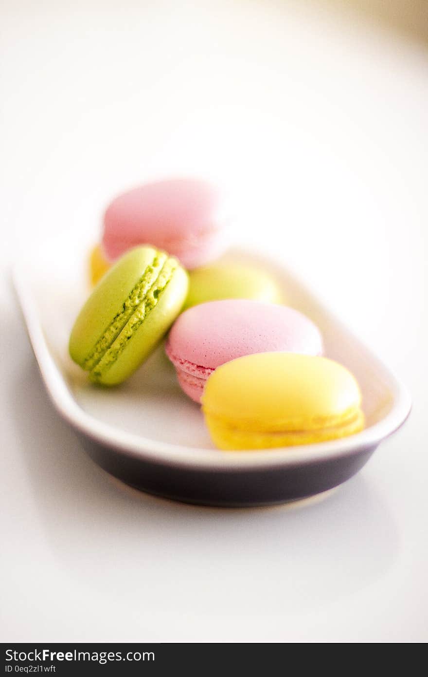 Colorful macaroons on place on white surface.