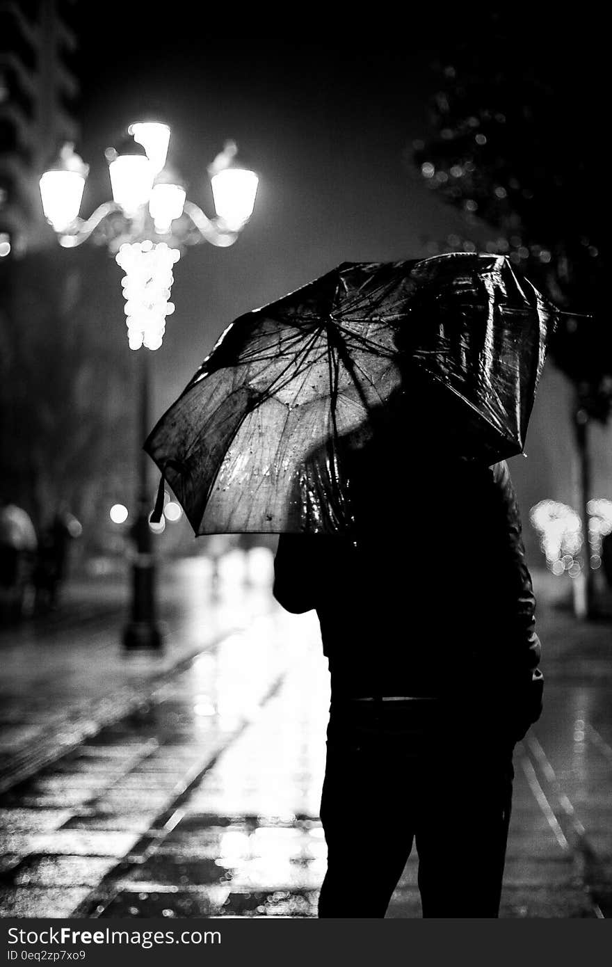 Man with umbrella in a rainy night in the city