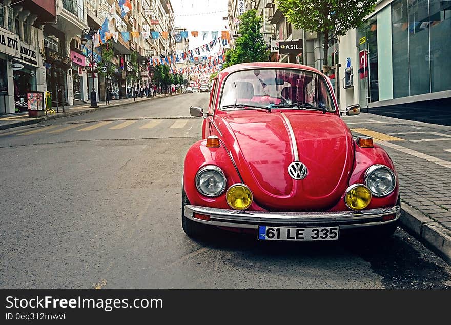 Red Volkswagen Beetle Parked at Road Side Near Pedestrian Lane