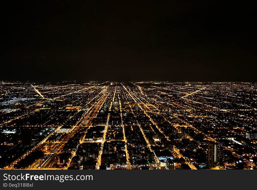 Birdseye view over illuminated city at night. Birdseye view over illuminated city at night