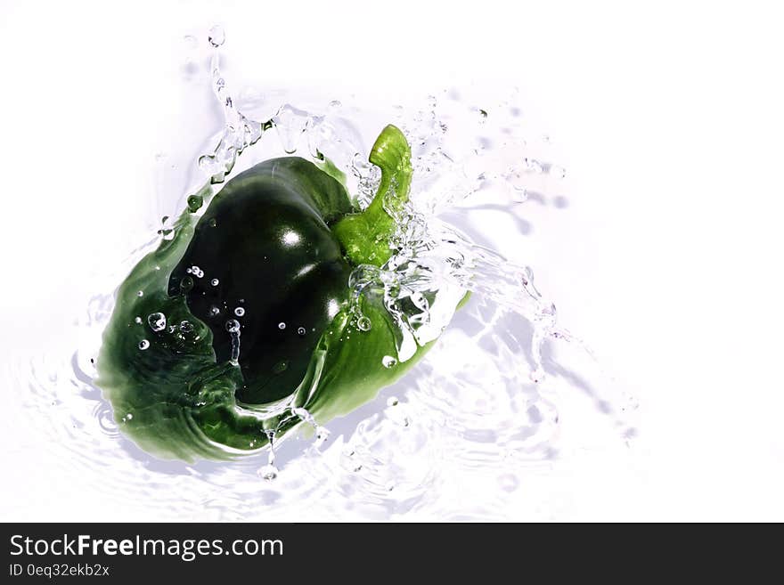 Fresh green bell pepper paprika splashing in Water. Fresh green bell pepper paprika splashing in Water