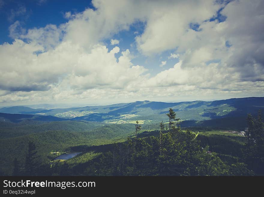 Green Mountain Under Cloudy Sky during Daytime