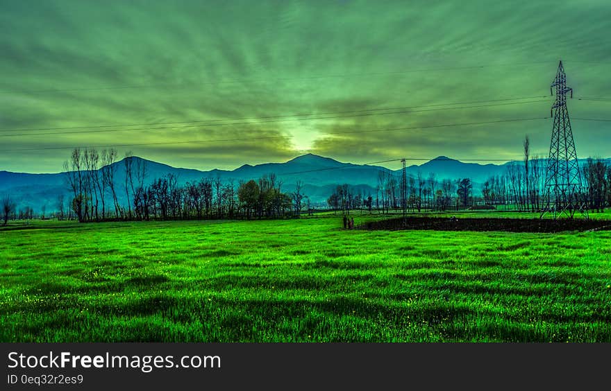 Silhouette Photography of Mountain Near Green Grass