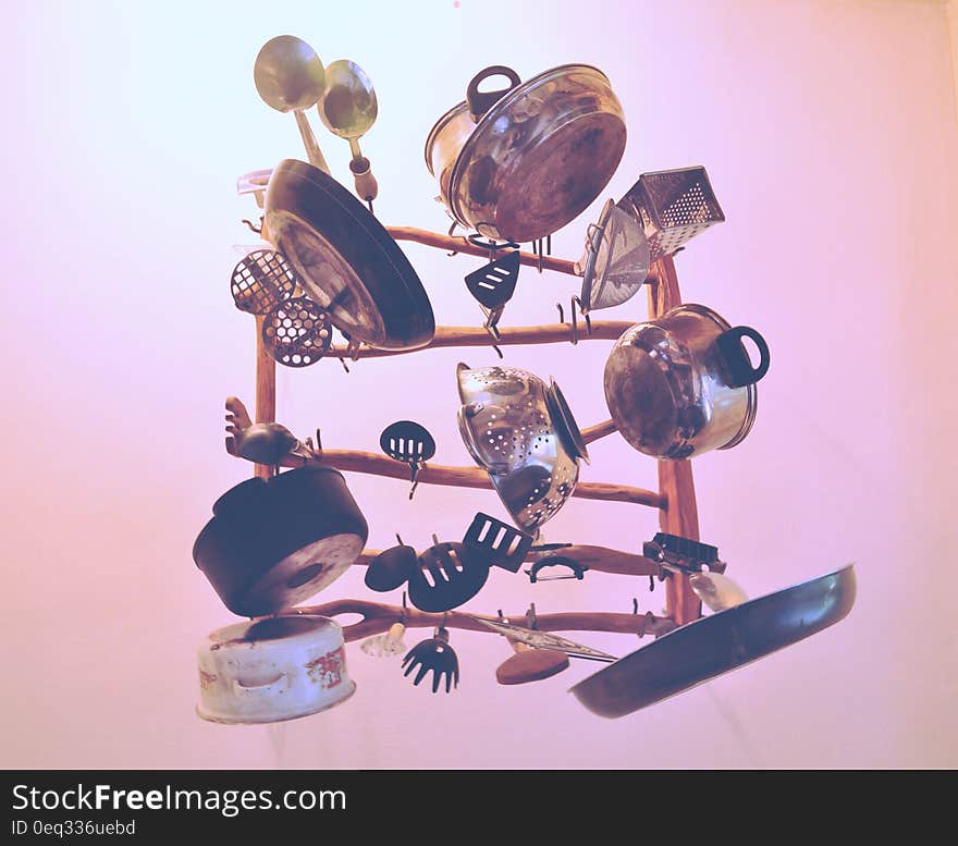 Kitchen Cookware Piled Up on Brown Wooden Rack