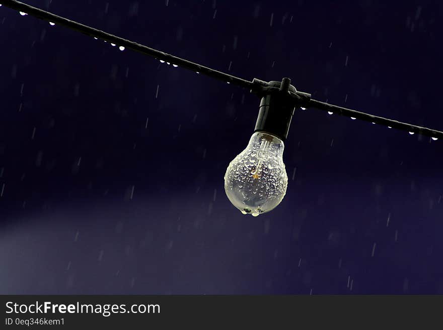 A bulb being rained over at night. A bulb being rained over at night