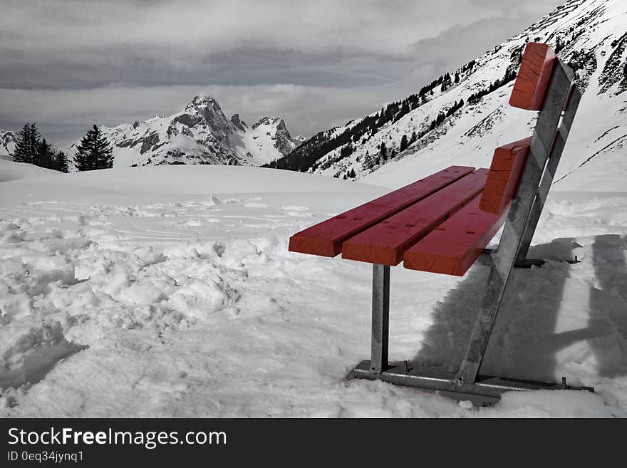 Grey and Brown Bench on Snow Near Mountain during Daytime