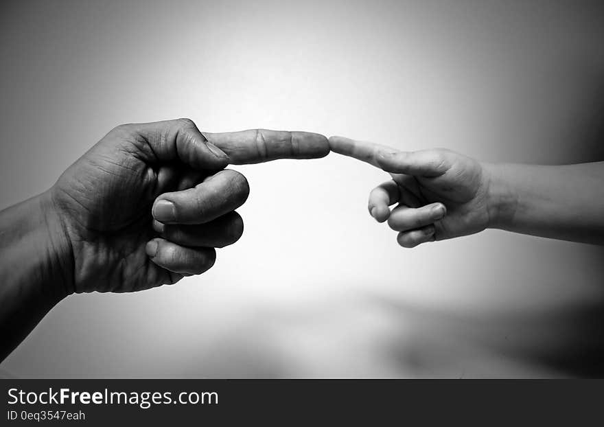 Grayscale Photo of Human Aligning Fingers