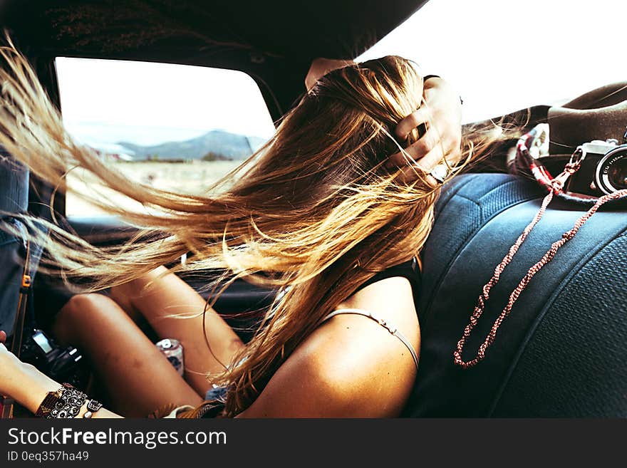 Fun girl in car going on a road trip adventure with her hair waving in the wind. Fun girl in car going on a road trip adventure with her hair waving in the wind