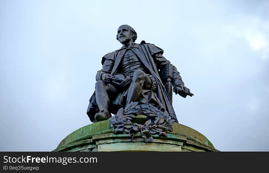 Photo of Black Ceramic Male Profile Statue Under Grey Sky during Daytime