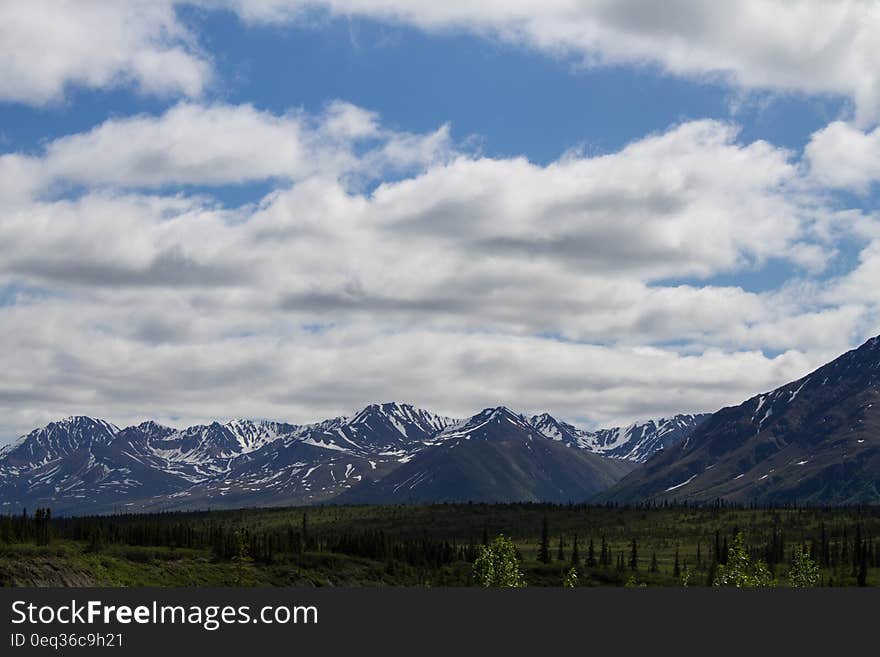 Landscape Photo of Mountain Under Blue Cloudy Sky