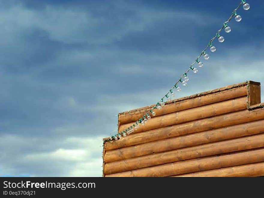 Brown Wooden Wall Connecting Clear Bulb