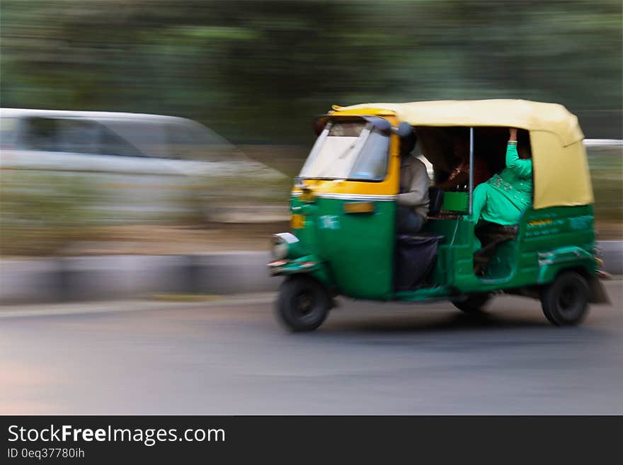 Green and Yellow 3 Wheeled Vehicle