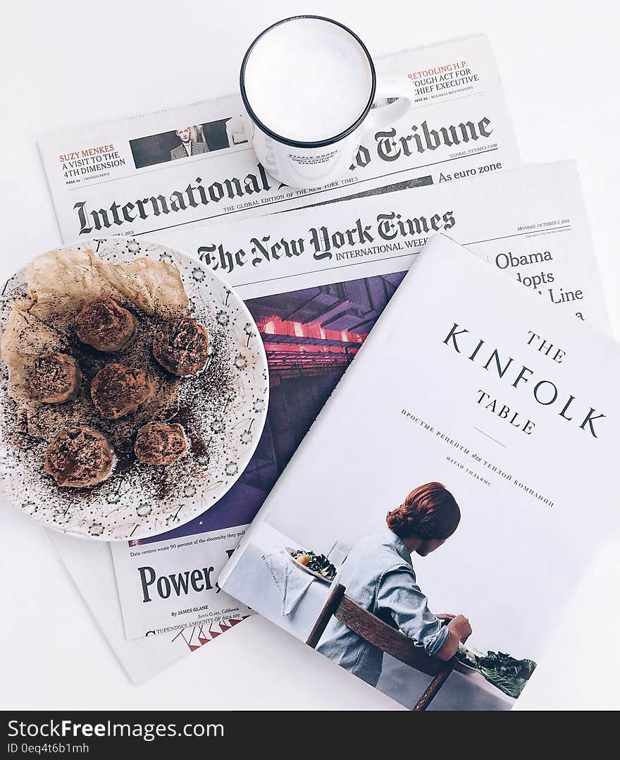 The Kinfolk Table Book Beside Baked Pastry on White Ceramic Plate With White Ceramic Mug