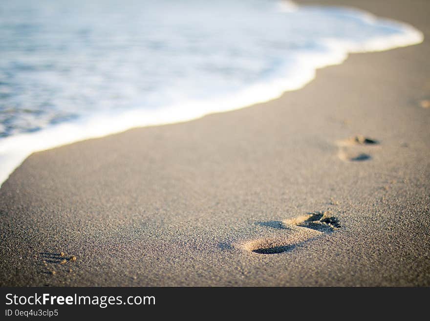 Footprints and sea water along beac on a sunny day. Footprints and sea water along beac on a sunny day.