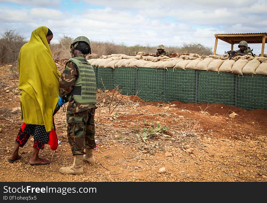 A Somali woman passes through a security check-point before entering a free medical clinic run by Ugandan and Burundian military personnel serving with the African Union Mission in Somalia (AMISOM) in Baidoa, the capital of Bay and Bakool region in central Somalia. The clinic is held twice weekly with up to 400-500 people on an average day, treating complaints ranging from sexually-transmitted diseases, to respiatory infections amd cardiac complications. AU/UN IST PHOTO / ABDI DAKAN. A Somali woman passes through a security check-point before entering a free medical clinic run by Ugandan and Burundian military personnel serving with the African Union Mission in Somalia (AMISOM) in Baidoa, the capital of Bay and Bakool region in central Somalia. The clinic is held twice weekly with up to 400-500 people on an average day, treating complaints ranging from sexually-transmitted diseases, to respiatory infections amd cardiac complications. AU/UN IST PHOTO / ABDI DAKAN.