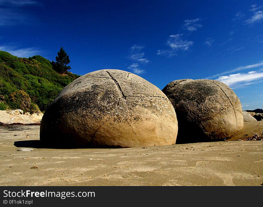 The Moeraki Boulders are geological marvels, exposed by erosion of sedimentary rocks laid down from 65 to 13 million years ago. They are formed by the gradual precipitation of calcite in mudstone over 4 million years. These spherical concretions are internationally significant for their scientific value and are a popular tourist attraction. Location Moeraki is on the East Coast of the South Island of New Zealand. 35 km south of Oamaru, and 80 km north of Dunedin.