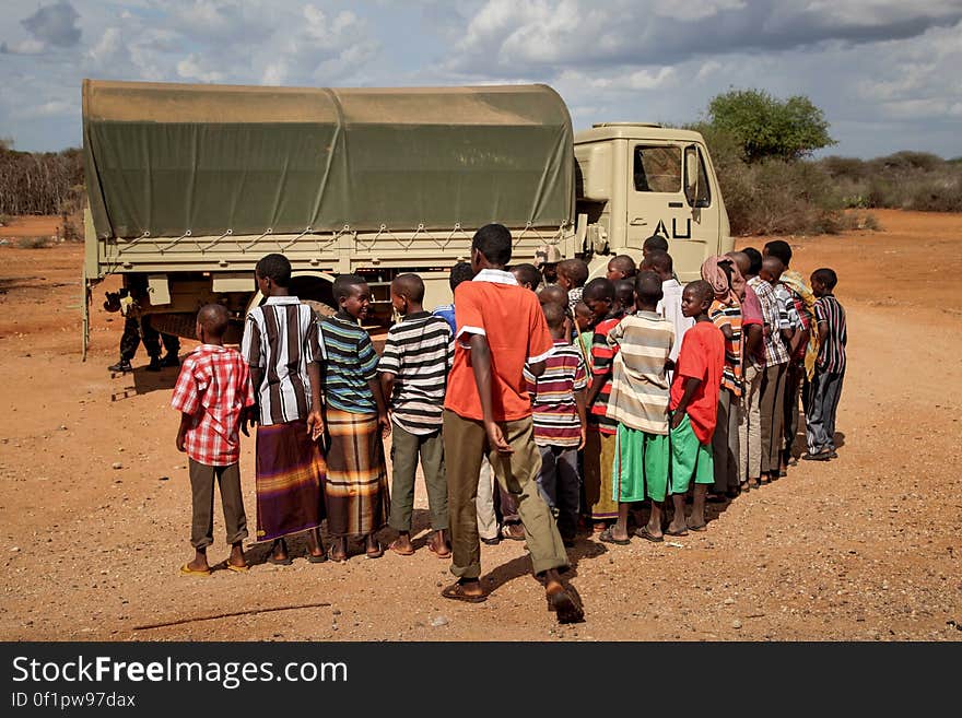 Children in the village of Modmoday, look on at an African Union Mission in Somalia &#x28;AMISOM&#x29; supply truck approx. 40km east of the central Somali town of Baidoa. Burundian troops serving with AMISOM together with forces of the SNA have been mounting &#x27;snap&#x27; foot patrols in villages and areas to the east of Baidoa where Al Qaeda-affiliated extremist group Al Shabaab mount attacks against local herdsmen, villages and travelers along the busy Baidoa-Mogadishu road. The AMISOM troops also use the patrols as an opportunity to provide occasional free medical treatment and fresh, potable drinking water for residents in the area. AU/UN IST PHOTO / ABDI DAKAN. Children in the village of Modmoday, look on at an African Union Mission in Somalia &#x28;AMISOM&#x29; supply truck approx. 40km east of the central Somali town of Baidoa. Burundian troops serving with AMISOM together with forces of the SNA have been mounting &#x27;snap&#x27; foot patrols in villages and areas to the east of Baidoa where Al Qaeda-affiliated extremist group Al Shabaab mount attacks against local herdsmen, villages and travelers along the busy Baidoa-Mogadishu road. The AMISOM troops also use the patrols as an opportunity to provide occasional free medical treatment and fresh, potable drinking water for residents in the area. AU/UN IST PHOTO / ABDI DAKAN.