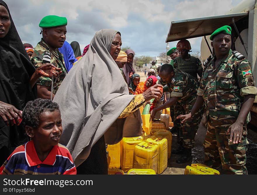 Burundian troops serving with the African Union Mission in Somalia &#x28;AMISOM&#x29; distribute fresh, potable drinking water in the village of Modmoday approx. 40km east of the central Somali town of Baidoa. The Burundians, together with forces of the Somali National Army &#x28;SNA&#x29; have been mounting &#x27;snap&#x27; foot patrols in villages and areas to the east of Baidoa where Al Qaeda-affiliated extremist group Al Shabaab mount attacks against local herdsmen, villages and travelers along the busy Baidoa-Mogadishu road. The AMISOM troops also use the patrols as an opportunity to provide occasional free medical treatment and drinking water for residents in the area. AU/UN IST PHOTO / ABDI DAKAN. Burundian troops serving with the African Union Mission in Somalia &#x28;AMISOM&#x29; distribute fresh, potable drinking water in the village of Modmoday approx. 40km east of the central Somali town of Baidoa. The Burundians, together with forces of the Somali National Army &#x28;SNA&#x29; have been mounting &#x27;snap&#x27; foot patrols in villages and areas to the east of Baidoa where Al Qaeda-affiliated extremist group Al Shabaab mount attacks against local herdsmen, villages and travelers along the busy Baidoa-Mogadishu road. The AMISOM troops also use the patrols as an opportunity to provide occasional free medical treatment and drinking water for residents in the area. AU/UN IST PHOTO / ABDI DAKAN.