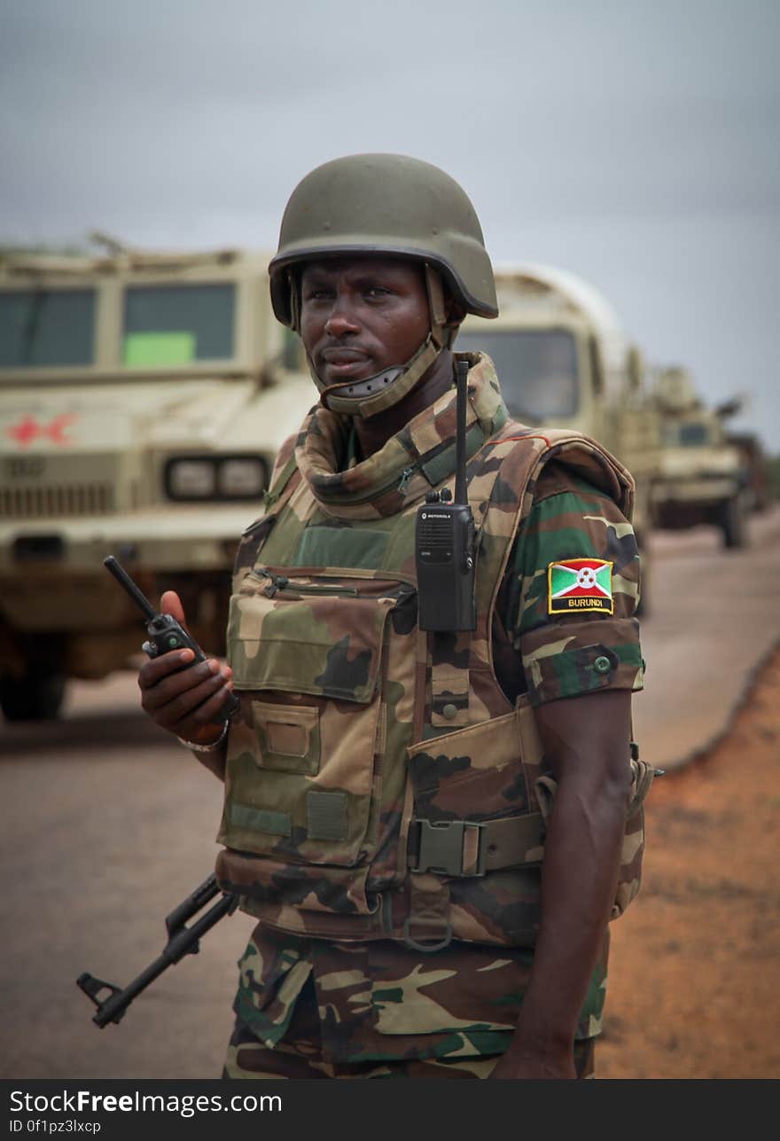 Burundian soldier serving with the African Union Mission in Somalia &#x28;AMISOM&#x29; communicates on a radio during a patrol near the village of Modmoday approx. 40km east of the central Somali town of Baidoa. The Burundians, together with forces of the Somali National Army &#x28;SNA&#x29; have been mounting &#x27;snap&#x27; foot patrols in villages and areas to the east of Baidoa where Al Qaeda-affiliated extremist group Al Shabaab mount attacks against local herdsmen, villages and travelers along the busy Baidoa-Mogadishu road. The AMISOM troops also use the patrols as an opportunity to provide occasional free medical treatment and fresh, potable drinking water for residents in the area. AU/UN IST PHOTO / ABDI DAKAN. Burundian soldier serving with the African Union Mission in Somalia &#x28;AMISOM&#x29; communicates on a radio during a patrol near the village of Modmoday approx. 40km east of the central Somali town of Baidoa. The Burundians, together with forces of the Somali National Army &#x28;SNA&#x29; have been mounting &#x27;snap&#x27; foot patrols in villages and areas to the east of Baidoa where Al Qaeda-affiliated extremist group Al Shabaab mount attacks against local herdsmen, villages and travelers along the busy Baidoa-Mogadishu road. The AMISOM troops also use the patrols as an opportunity to provide occasional free medical treatment and fresh, potable drinking water for residents in the area. AU/UN IST PHOTO / ABDI DAKAN.