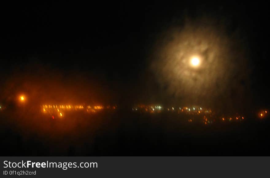 haloed moon with city lights