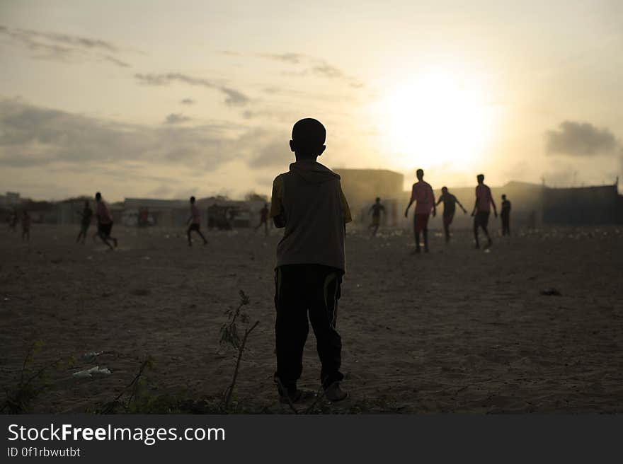 A young child looks on as older boys play football next to an IDP camp in Mogadishu, Somalia, on August 19. Illegal under al Shabab, football has made a huge comeback in Somalia, with Mogadishu&#x27;s streets literally filling up with children each afternoon as they come out to play the game. AU UN IST PHOTO / TOBIN JONES. A young child looks on as older boys play football next to an IDP camp in Mogadishu, Somalia, on August 19. Illegal under al Shabab, football has made a huge comeback in Somalia, with Mogadishu&#x27;s streets literally filling up with children each afternoon as they come out to play the game. AU UN IST PHOTO / TOBIN JONES.