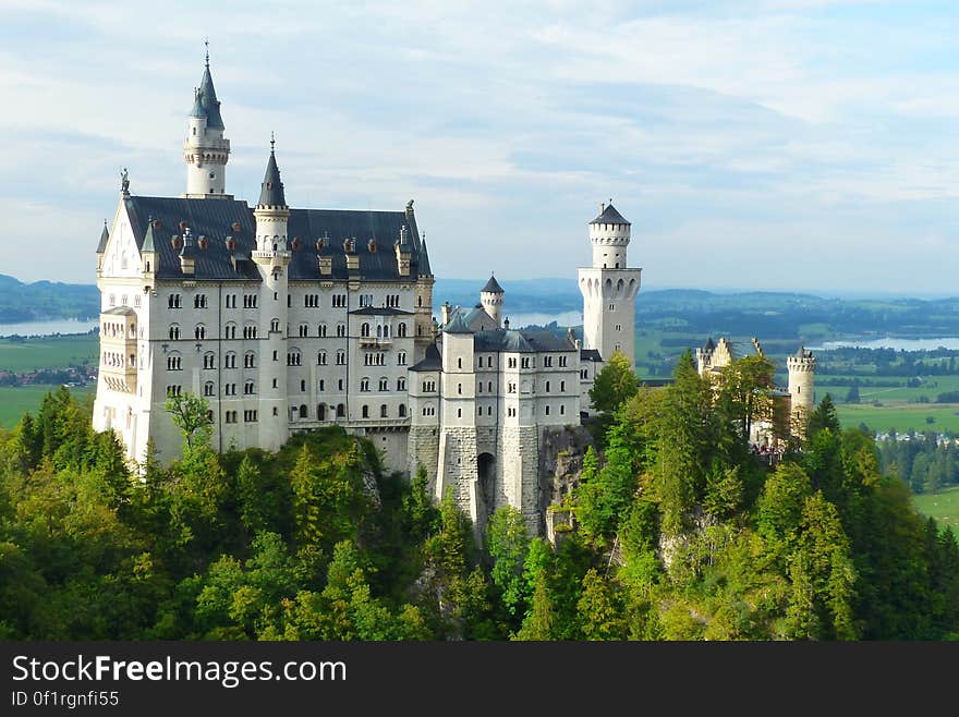 A view of an ancient castle surrounded by a forest. A view of an ancient castle surrounded by a forest.