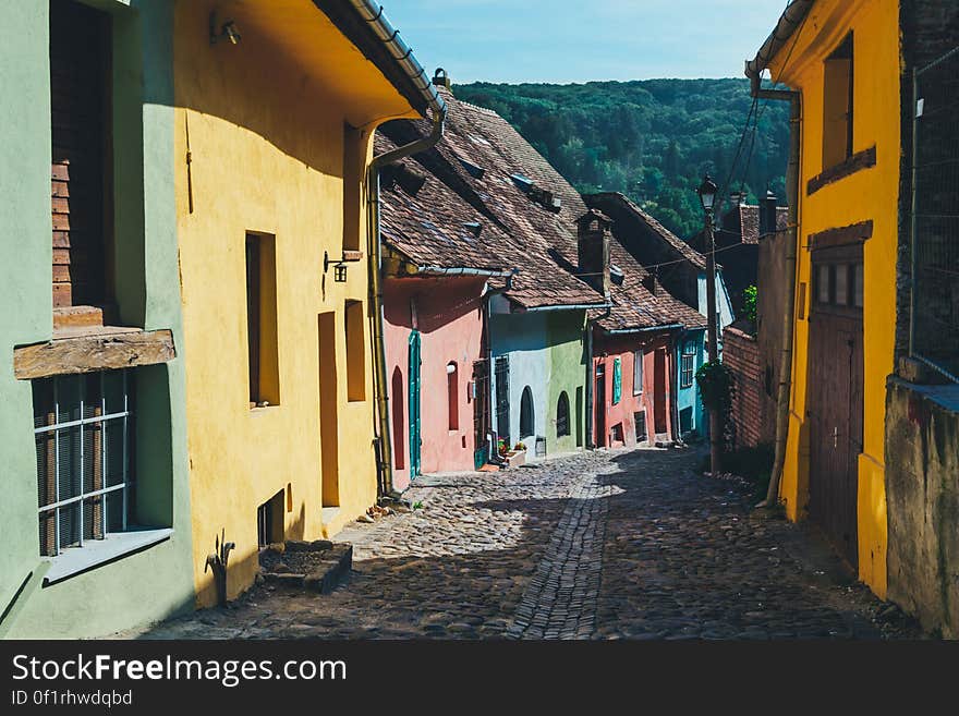 A row of humble colorful houses along a cobbled alley. A row of humble colorful houses along a cobbled alley.