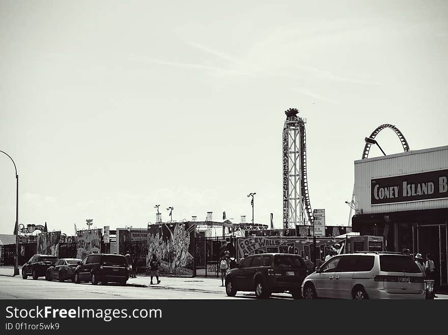 Grayscale Photo of Car Parked Near Bulding