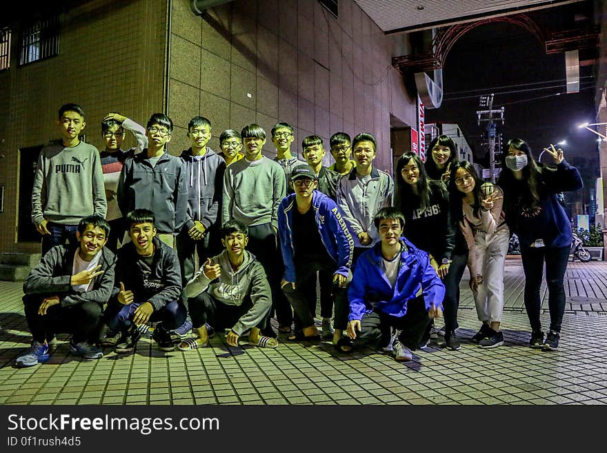 A bunch of teenage kids out on a street at night. A bunch of teenage kids out on a street at night.