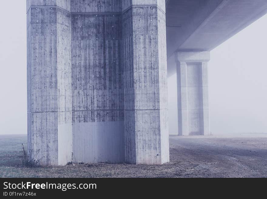 A concrete pylon holding a bridge or raised road.