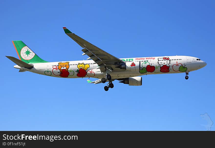 Hello Kitty characters on outside of commercial airliner in flight against blue skies. Hello Kitty characters on outside of commercial airliner in flight against blue skies.