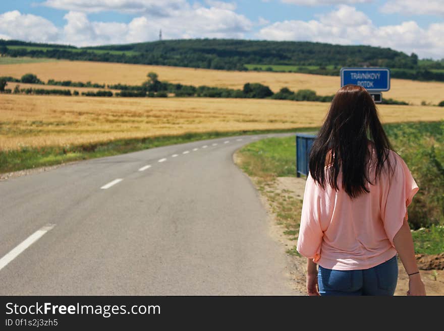 Back View of Woman on Road Against Sky