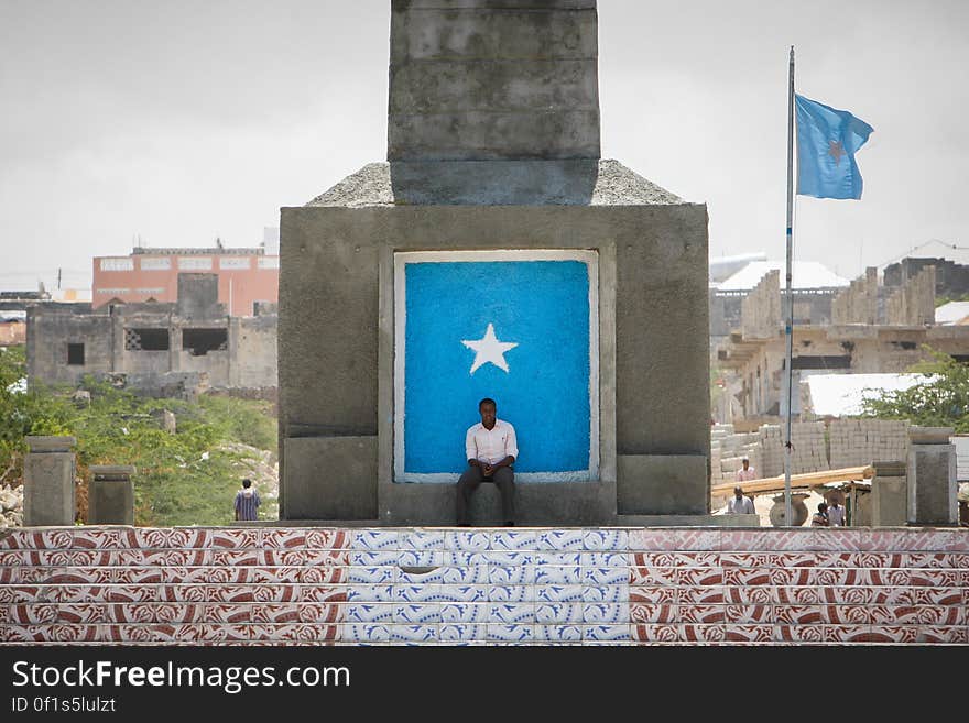 A man sits at the bases of the newly renovated Monument to the Unknown Warrior in the Boondheere district of the Somali capital Mogadishu, 05 August, 2013. 06 August marks 2 years since the Al Qaeda-affiliated extremist group Al Shabaab withdrew from Mogadishu following sustained operations by forces of the Somali National Army &#x28;SNA&#x29; backed by troops of the African Union Mission in Somalia &#x28;AMISOM&#x29; to retake the city. Since the group&#x27;s departure the country&#x27;s captial has re-established itself and a sense of normality has returned. Buildings and infrastructure devastated and destroyed by two decades of conflict have been repaired; thousands of Diaspora Somalis have returned home to invest and help rebuild their nation; foreign embassies and diplomatic missions have reopened and for the first time in many years, Somalia has an internationally recognised government.. AU-UN IST PHOTO / STUART PRICE. A man sits at the bases of the newly renovated Monument to the Unknown Warrior in the Boondheere district of the Somali capital Mogadishu, 05 August, 2013. 06 August marks 2 years since the Al Qaeda-affiliated extremist group Al Shabaab withdrew from Mogadishu following sustained operations by forces of the Somali National Army &#x28;SNA&#x29; backed by troops of the African Union Mission in Somalia &#x28;AMISOM&#x29; to retake the city. Since the group&#x27;s departure the country&#x27;s captial has re-established itself and a sense of normality has returned. Buildings and infrastructure devastated and destroyed by two decades of conflict have been repaired; thousands of Diaspora Somalis have returned home to invest and help rebuild their nation; foreign embassies and diplomatic missions have reopened and for the first time in many years, Somalia has an internationally recognised government.. AU-UN IST PHOTO / STUART PRICE.