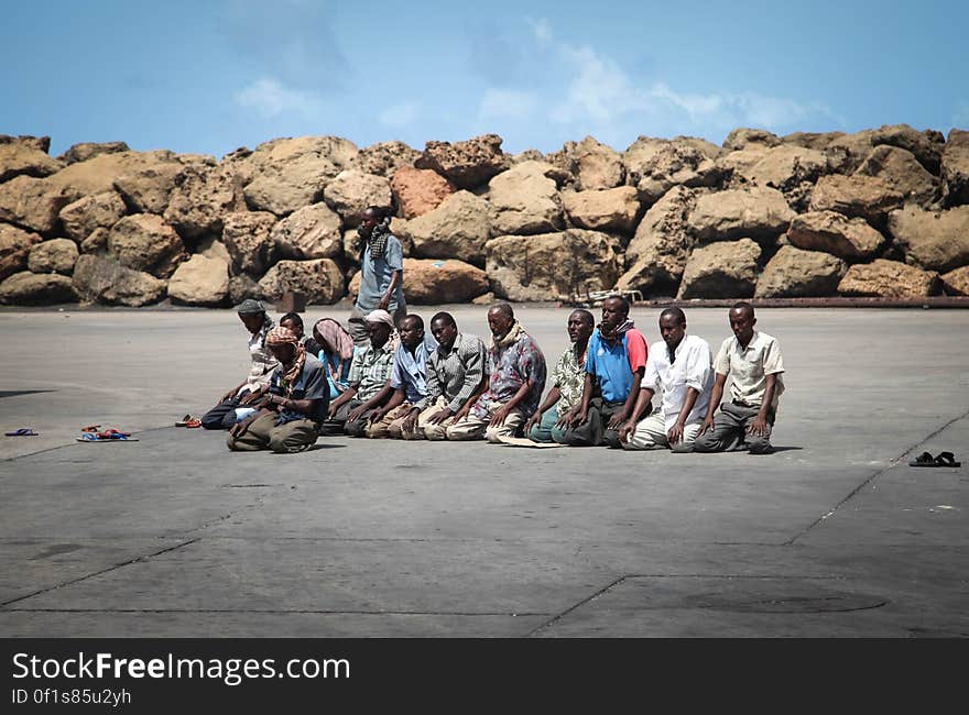 SOMALIA, Kismayo: In a photograph taken 15 July 2013 and released by the African Union-United Nations Information Support Team 22 July, workers at Kismayo Seaport in southern Somalia pray during the holy month of Ramadan. AU-UN IST PHOTO / RAMADAN MOHAMED HASSAN. SOMALIA, Kismayo: In a photograph taken 15 July 2013 and released by the African Union-United Nations Information Support Team 22 July, workers at Kismayo Seaport in southern Somalia pray during the holy month of Ramadan. AU-UN IST PHOTO / RAMADAN MOHAMED HASSAN.