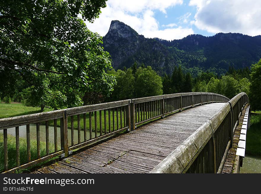 A bridge crossing a river with mountains in the distance. A bridge crossing a river with mountains in the distance.