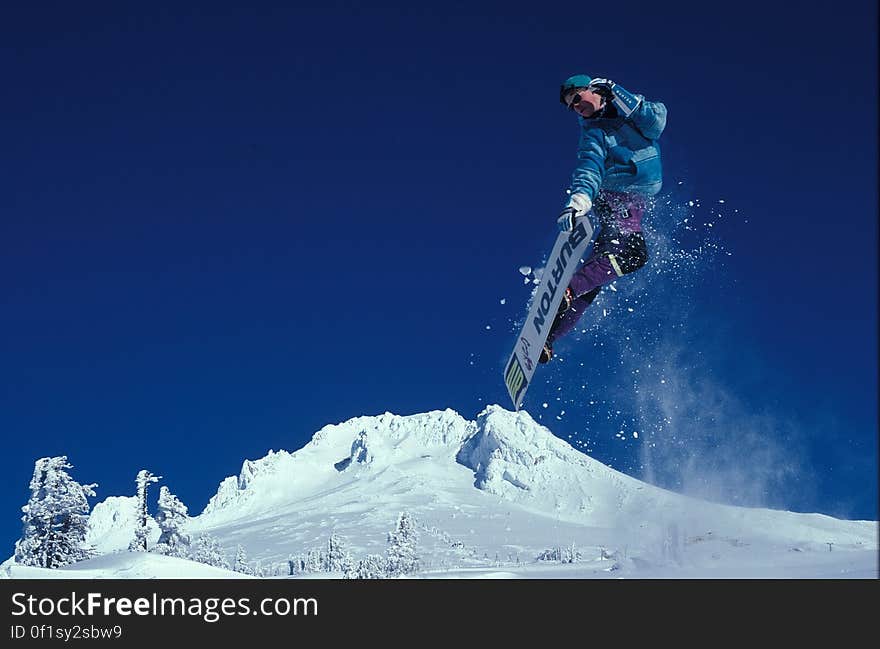 Man Snowboarding during Daytime