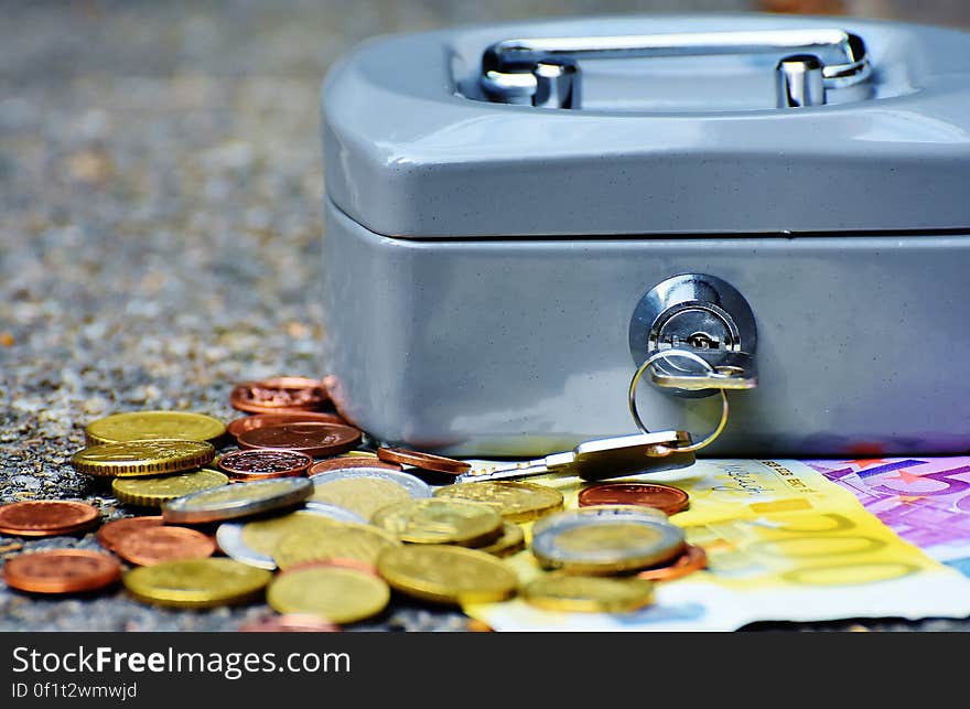 Coins and Bill Beside Coin Case