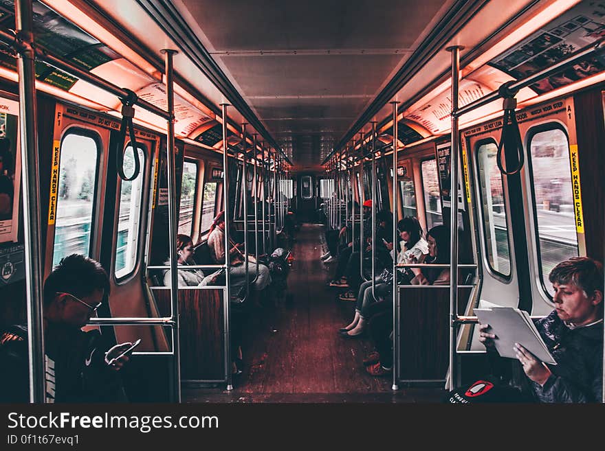 Interior view of commuters sat on a passenger train in city. Interior view of commuters sat on a passenger train in city.