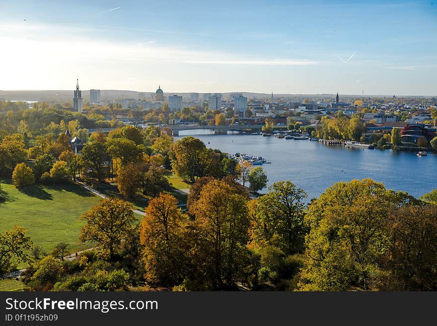 A green park and blue river passing through a city. A green park and blue river passing through a city.