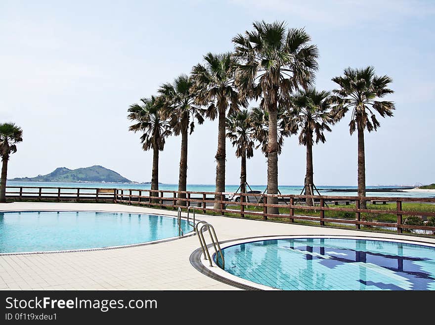 A view of a tropical resort with swimming pools.