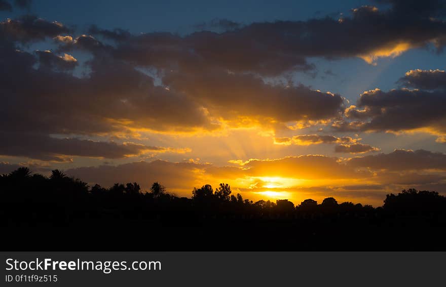 Scenic view of golden sunset in the countryside with cloudscape background. Scenic view of golden sunset in the countryside with cloudscape background.