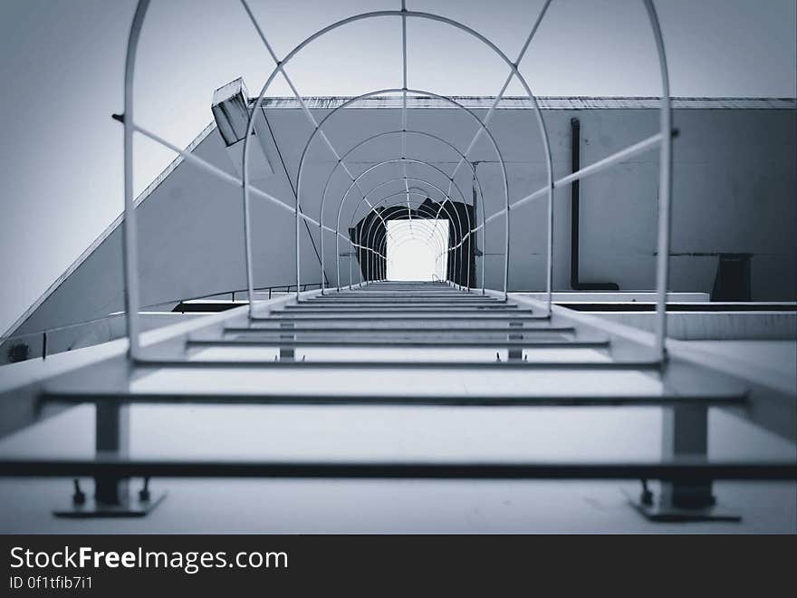 View looking up steel fire escape ladder on modern building.