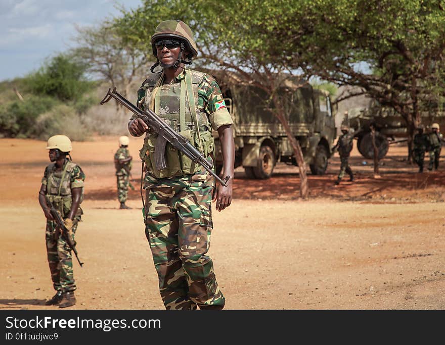 Burundian troops serving with the African Union Mission in Somalia &#x28;AMISOM&#x29; stand during a patrol near the village of Modmoday approx. 40km east of the central Somali town of Baidoa. The Burundians, together with forces of the Somali National Army &#x28;SNA&#x29; have been mounting &#x27;snap&#x27; foot patrols in villages and areas to the east of Baidoa where Al Qaeda-affiliated extremist group Al Shabaab mount attacks against local herdsmen, villages and travelers along the busy Baidoa-Mogadishu road. The AMISOM troops also use the patrols as an opportunity to provide occasional free medical treatment and fresh, potable drinking water for residents in the area. AU/UN IST PHOTO / ABDI DAKAN. Burundian troops serving with the African Union Mission in Somalia &#x28;AMISOM&#x29; stand during a patrol near the village of Modmoday approx. 40km east of the central Somali town of Baidoa. The Burundians, together with forces of the Somali National Army &#x28;SNA&#x29; have been mounting &#x27;snap&#x27; foot patrols in villages and areas to the east of Baidoa where Al Qaeda-affiliated extremist group Al Shabaab mount attacks against local herdsmen, villages and travelers along the busy Baidoa-Mogadishu road. The AMISOM troops also use the patrols as an opportunity to provide occasional free medical treatment and fresh, potable drinking water for residents in the area. AU/UN IST PHOTO / ABDI DAKAN.