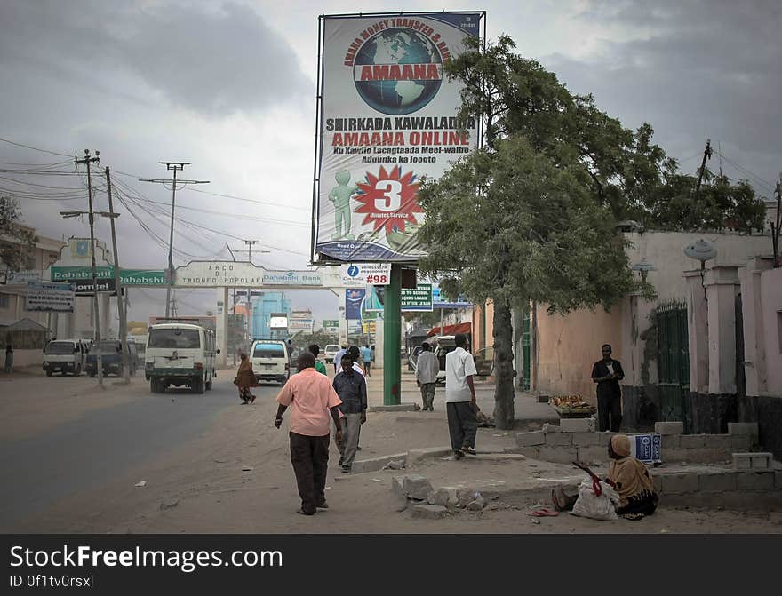 Billboards displaying advertisements for international money transfer companies, are seen new the Kilometre 4 junction in the Somali capital Mogadishu. Millions of people in the Horn of Africa nation Somalia rely on money sent from their relatives and friends abroad in the form of remittances in order to survive, but it is feared that a decision by Barclays Bank to close the accounts of some of the biggest Somali money transfer firms – due to be announced this week - will have a devastating effect on the country and its people. According to the United Nations Development Programme &#x28;UNDP&#x29;, an estimated $1.6 billion US dollars is sent back annually by Somalis living in Europe and North America. Some money transfer companies in Somalia have been accused of being used by pirates to launder money received form ransoms as well as used by Al Qaeda-affiliated extremist group al Shabaab group to fund their terrorist activities and operations in Somalia and the wider East African region. AU/UN IST PHOTO / STUART PRICE. Billboards displaying advertisements for international money transfer companies, are seen new the Kilometre 4 junction in the Somali capital Mogadishu. Millions of people in the Horn of Africa nation Somalia rely on money sent from their relatives and friends abroad in the form of remittances in order to survive, but it is feared that a decision by Barclays Bank to close the accounts of some of the biggest Somali money transfer firms – due to be announced this week - will have a devastating effect on the country and its people. According to the United Nations Development Programme &#x28;UNDP&#x29;, an estimated $1.6 billion US dollars is sent back annually by Somalis living in Europe and North America. Some money transfer companies in Somalia have been accused of being used by pirates to launder money received form ransoms as well as used by Al Qaeda-affiliated extremist group al Shabaab group to fund their terrorist activities and operations in Somalia and the wider East African region. AU/UN IST PHOTO / STUART PRICE.