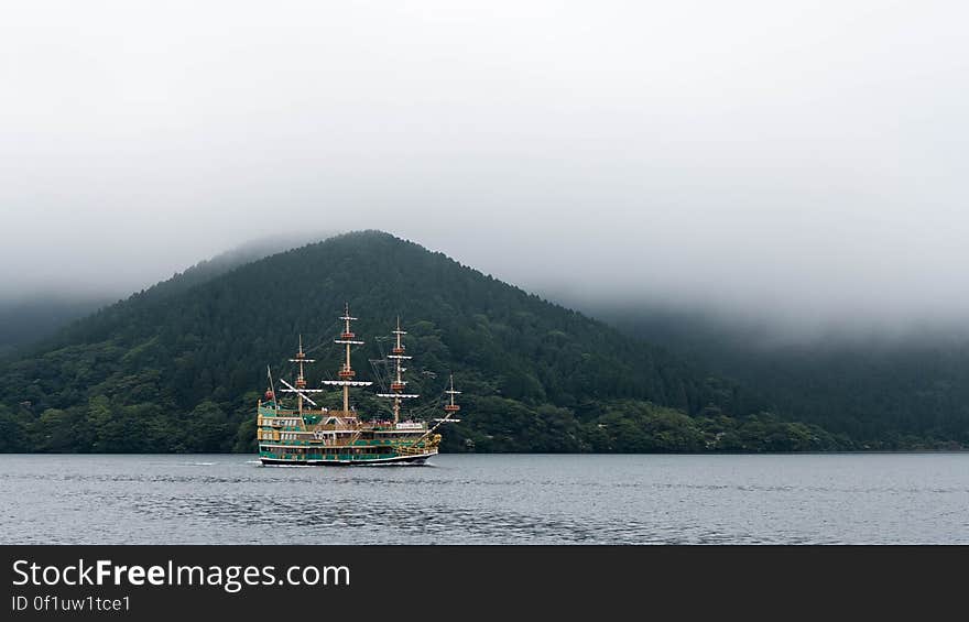 Ship on waters along foggy coastline. Ship on waters along foggy coastline.